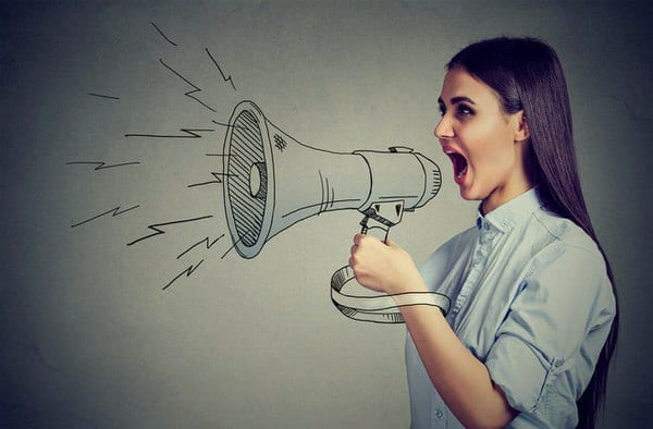 Stop Negative Self Talk woman shouting into loudspeaker
