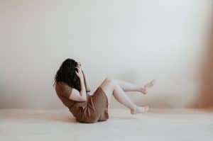 woman in panic sitting on floor